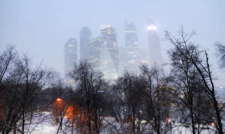 Evening view of Moscow city skyscraper buildings during heavy snowfallの写真素材