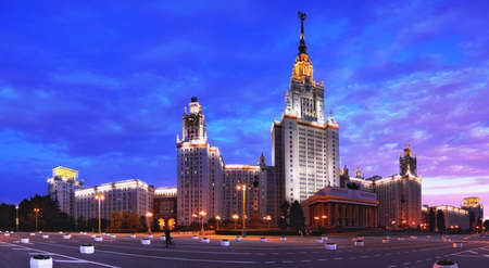 Wide angle fisheye panoramic evening view of nicely illuminated famous Russian university under dramatic sunset cloudy skyの写真素材