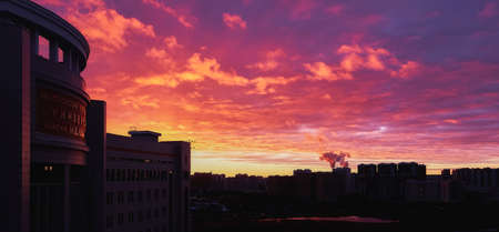 Moscow, Russia - March 15 2021: Sunset silhouettes of Moscow university building under dramatic cloudy skyの写真素材