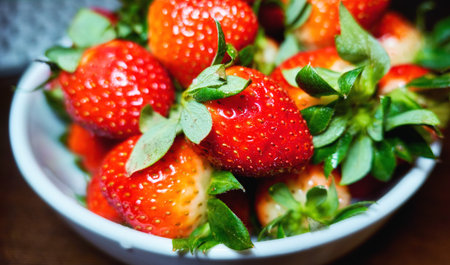 Juicy strawberry on white ceramic plate close upの写真素材