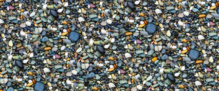 Wet round stones on sea coast near Sochiの写真素材