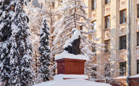 Moscow, Russia - April 5 2021: Fragments of building in campus of Moscow university, Dmitry Mendeleev monument covered with snowのeditorial素材