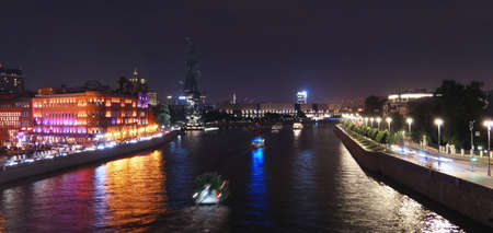 Moscow, Russia - August 1st 2021: Illuminated Moscow river tonight with nice reflections and historical buildings of Red October chocolate plantのeditorial素材