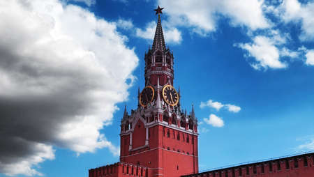 Moscow, Russia - August 10 2021: Kremlin clock tower and Red Wall under blue cloudy sky