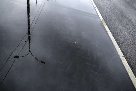 Water reflections of Moscow street in wet rainy asphalt roadの写真素材