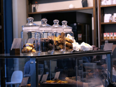 Glass bottles with sweet cookies in evening cafe in Moscowの写真素材