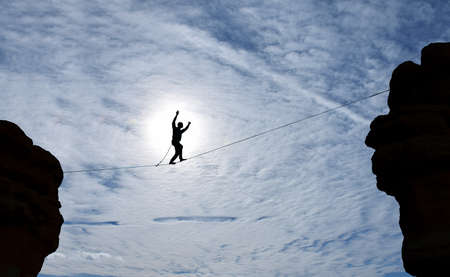 Highline walker between two roofs concept of risk taking and challengeの写真素材
