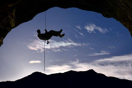 Silhouette of rock climber unique perspectiveの写真素材