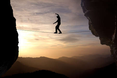 Silhouette of man on the rope concept of risk taking and challenge