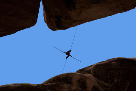 Silhouette of man on the rope concept of risk taking and challengeの写真素材