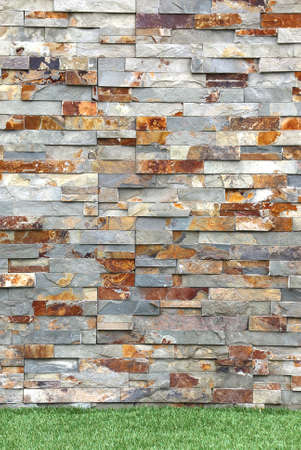 Stacked Stone Cladding covers wall exterior details with grass