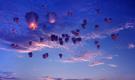 Large group of Chinese lanterns flying over blue sky backgroundの写真素材