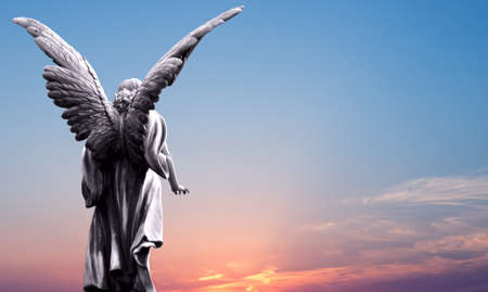Angel sculpture on beautiful sky background concept of Religionの写真素材