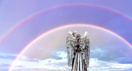 Angel with double rainbows with angel over bright skyの写真素材