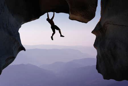 Man rock climber silhouette concepts of Courage and Adventureの写真素材