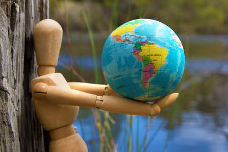 Wooden Doll Man Figure holding earth globe deforestation in Australia concept