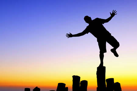 Man in good spirits standing on one leg concept of happinessの写真素材