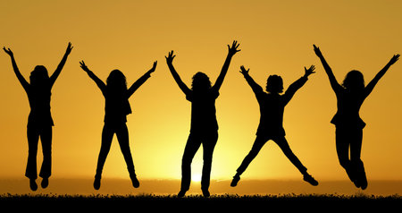 Group of five happy friends jumps at sunset backdrop, friendship and unity conceptの写真素材