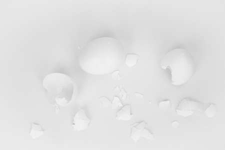 White broken eggs and shells on a white backgroundの写真素材