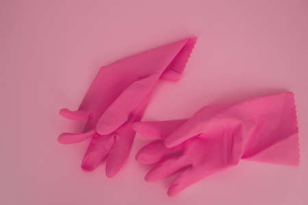 pink gloves for cleaning on a pink backgroundの写真素材