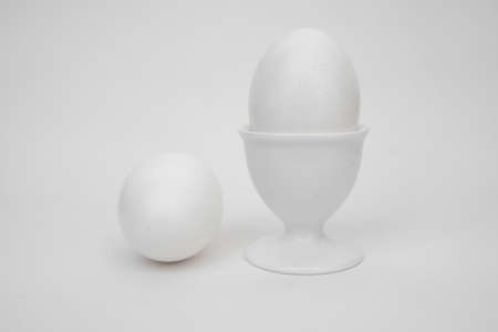 White eggs on a white background, with a cupの写真素材