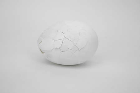 White cracked egg on a white backgroundの写真素材