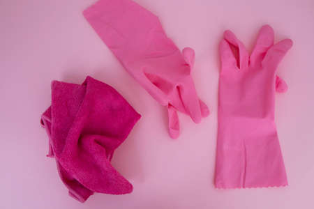 pink gloves for cleaning on a pink background