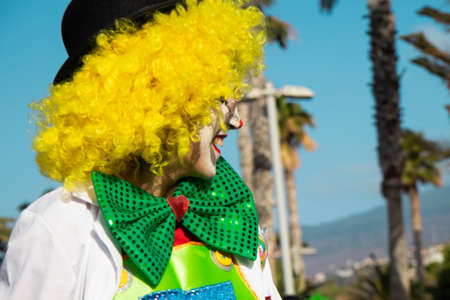 PUERTO DE LA CRUZ, SPAIN - FEBRUARY 29, 2020: The official end of the Carnival. Marching carnival groups, dancing, decorated cars and Carnival queens. Clown among other clownsのeditorial素材