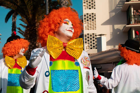 PUERTO DE LA CRUZ, SPAIN - FEBRUARY 29, 2020: The official end of the Carnival. Marching carnival groups, dancing, decorated cars and Carnival queens. Clown among other clownsのeditorial素材