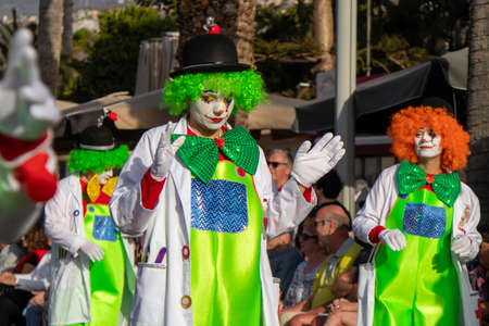 PUERTO DE LA CRUZ, SPAIN - FEBRUARY 29, 2020: The official end of the Carnival. Marching carnival groups, dancing, decorated cars and Carnival queens. Clown among other clownsのeditorial素材