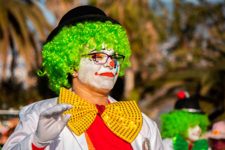 PUERTO DE LA CRUZ, SPAIN - FEBRUARY 29, 2020: The official end of the Carnival. Marching carnival groups, dancing, decorated cars and Carnival queens. Clown among other clownsのeditorial素材