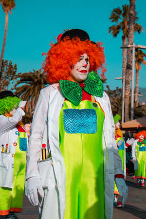 PUERTO DE LA CRUZ, SPAIN - FEBRUARY 29, 2020: The official end of the Carnival. Marching carnival groups, dancing, decorated cars and Carnival queens. Clown among other clownsのeditorial素材