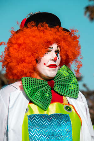 PUERTO DE LA CRUZ, SPAIN - FEBRUARY 29, 2020: The official end of the Carnival. Marching carnival groups, dancing, decorated cars and Carnival queens. Clown among other clownsのeditorial素材