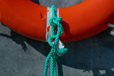 Orange lifebelt hanging on a wall