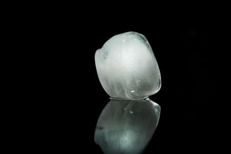 Ice cube on a black background