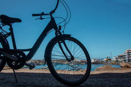 Silhouette of a part of a bicycle with a sea view in Valle Gran Ray, La Gomera, Canary islands, Spainの写真素材