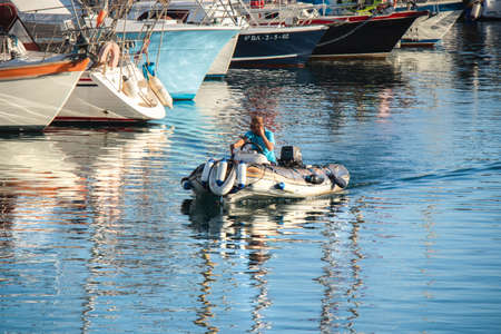 Port of boats and yachts with reflection in the water, San Sebastian, La Gomera, Spain