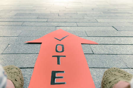 Symbolism with the election of politicians, an arrow with the inscription vote and feetの写真素材