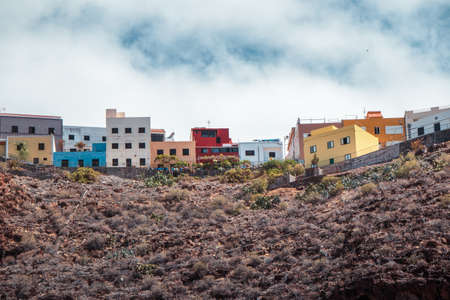 Colorful houses on a hill under the blue sky in San Sebastian, La Gomera, Canary islandの写真素材
