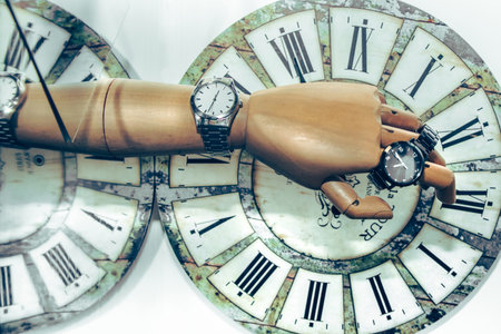 Abstract composition with clocks and a wooden hand reflecting the time