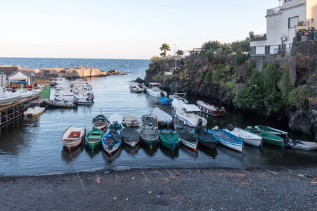 tourist pier with fishermen wod boatの写真素材