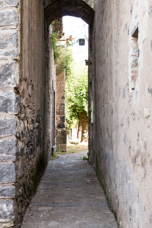 Narrow passage in an ancient castle with lava stoneの写真素材