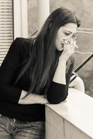 True sicilian Smoking woman in a terraceの写真素材