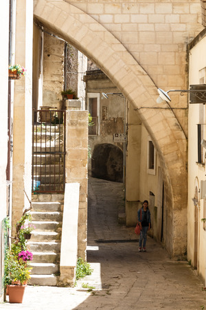 Girl near building under arc and storical constructionの写真素材