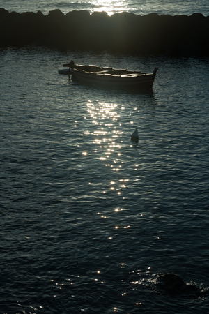 Woden boat at sunrise after fisherman come backの写真素材