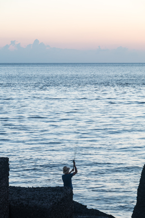Fishermen on the pier placed on a Sunday morningの写真素材