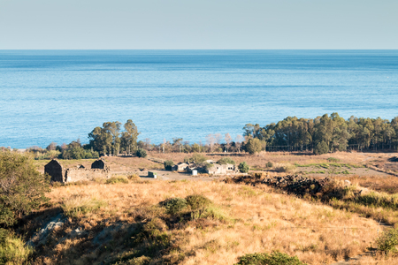 Ruins of an abandoned farm now on the Ionian coast of Sicilyの写真素材