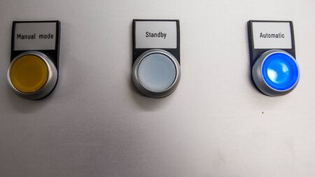 electric switches with colored lamps and legendの写真素材