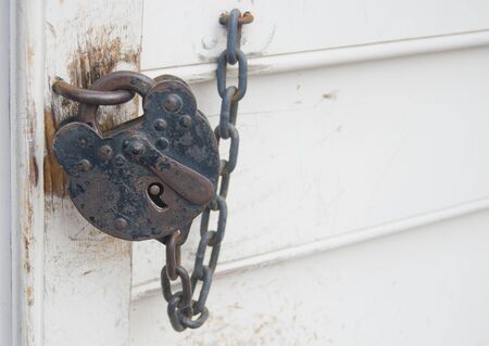 Old lock attached to the wall の写真素材