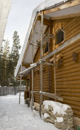 Wooden house under construction in winterの写真素材